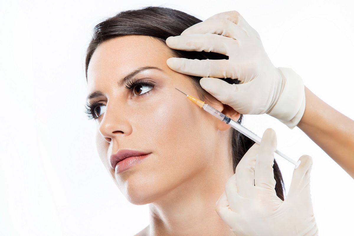woman receiving a Botox injection near the outer corner of her eye