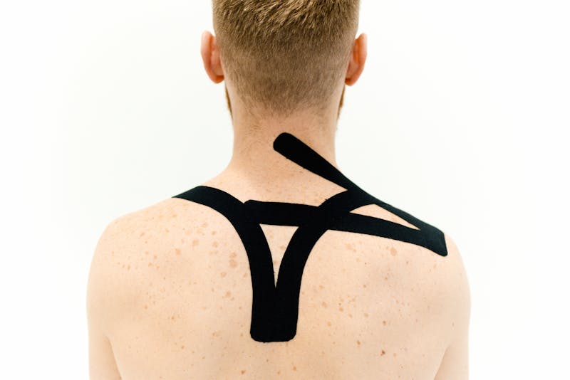 a man with pain patches on his upper back